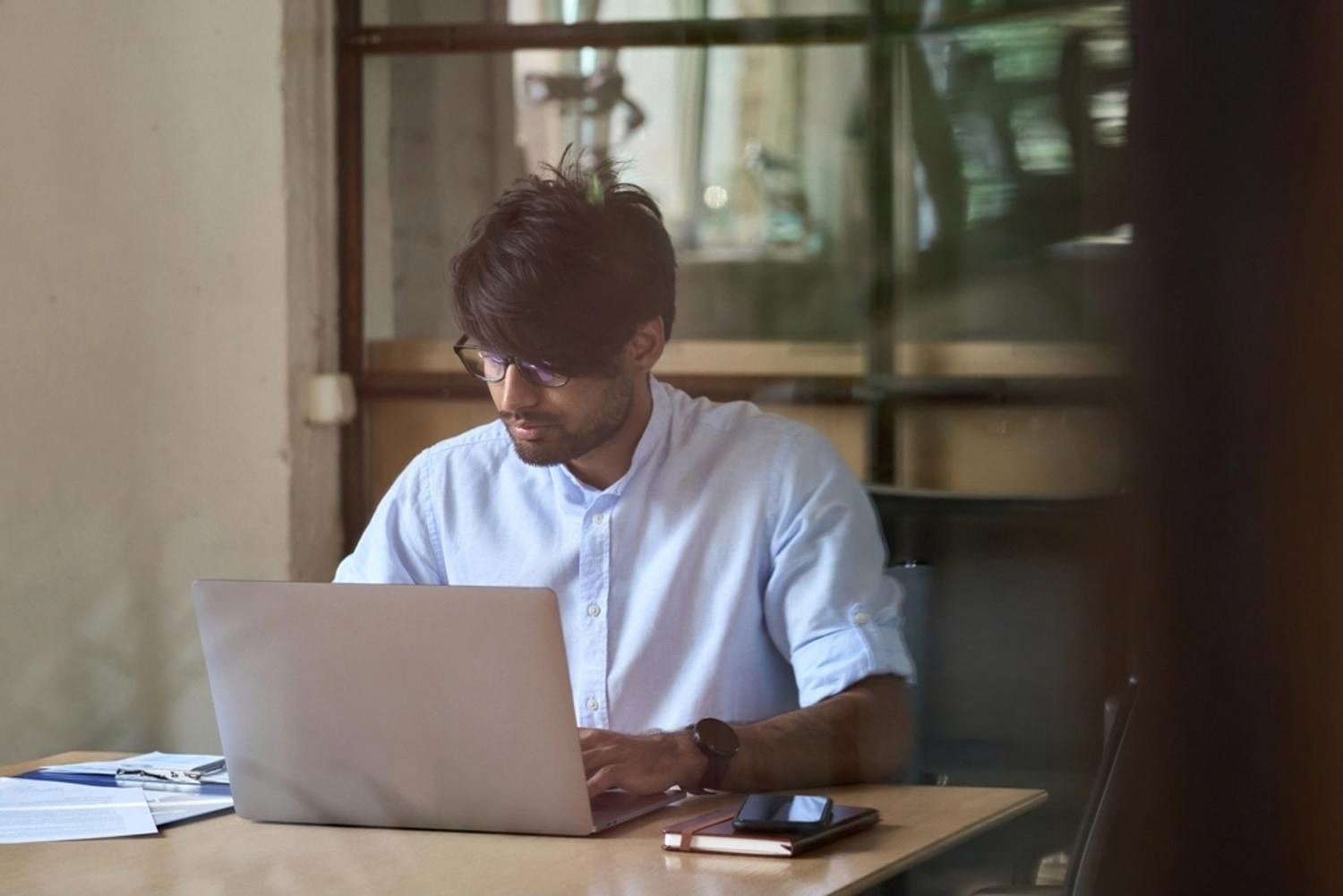 UAE small business owner working on a laptop to build a company website